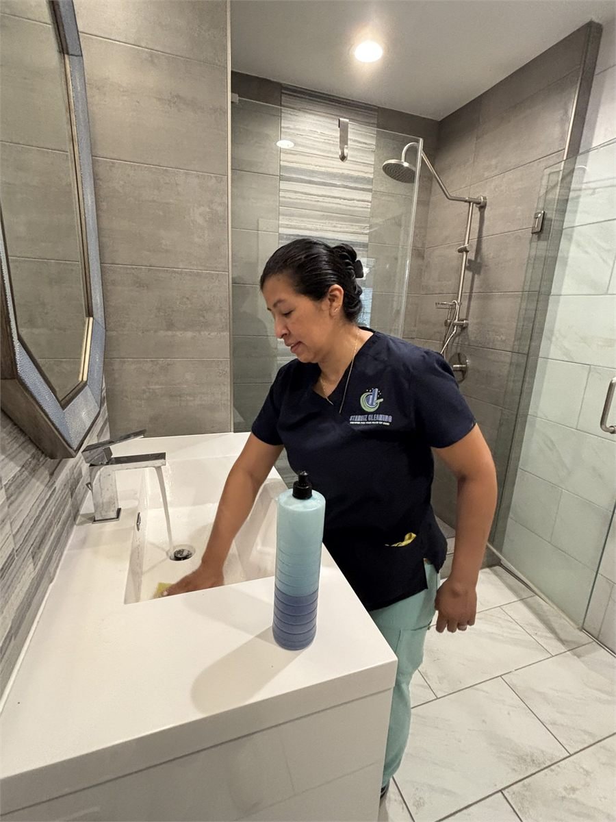 Starbiz cleaner detailing a glass shower enclosure