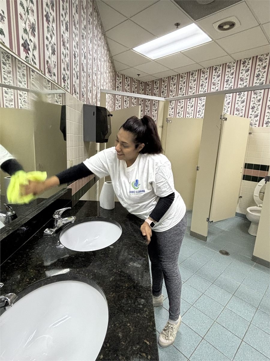 Starbiz cleaner mopping a hard floor in an office